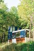 Modern home with Exterior, Cabin Building Type, Flat RoofLine, and Glass Siding Material. Set in the lush Wisconsin forest, this neatly stacked cabin was built vertically in order to minimize the amount of grading and landscaping necessary for construction. Photo by: Narayan Mahon Photo of Architects Get Crafty With Budgets to Build Cost-Effective Modern Homes