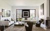 Since a sophisticated, modern look was imperative to the architectural design, the same was expected of the furnishings. A B&B Italia Charles sofa, chaise lounge, and Piccola Papilio chairs fill the living room. Trípode Floor Lamps by Santa & Cole frame the sofa. Photo of Back Bay modern home