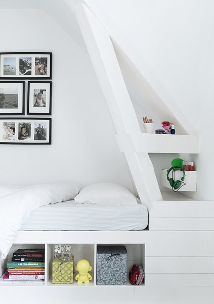 Custom details like this corner bed with built-in shelving keep the younger generation’s spaces playful, but still sophisticated. With four children, utilizing space wisely became a top priority, and the family relies on custom shelving and built-ins to keep clutter at bay. The bed is custom with IKEA frames.