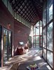 A view across the screen porch from the entrance to the kitchen, with the horizontal window, and the bedroom, reached through the French doors at rear left. Photo 8 of Texas Bunkhouse modern home