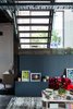 The built-in storage bench under the stairs is clad in wood paneling painted with Companion by Dulux. Photo by Phu Tang. Photo of Tour Modern, Colorful Design Files Show House in Sydney modern home