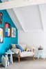 A Wilfred armchair by Jardan is accented by pillows from Penelope Durston and L.O.T.S. Artwork is by Rachel Castle, and walls are painted in Waterworld by Dulux. Photo by Phu Tang. Photo of Tour Modern, Colorful Design Files Show House in Sydney modern home