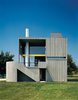 Modern home with Exterior, Wood Siding Material, and House. The wood-frame residence and studio are clad in vertical cedar siding—back then, a daring competitor to clapboard—instead of concrete to save costs. The effect is equally seamless, however: “If you drive by it fast enough,” Charles Gwathmey once said, “you still might mistake it for a concrete house.” Photo by Norman McGrath. Photo of 16 Funky Facades