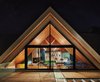Modern home with Exterior, House Building Type, A-Frame RoofLine, Cabin Building Type, Glass Siding Material, and Wood Siding Material. The Owner’s Suite at the Drake Devonshire is located under a dramatic A-frame clad with Douglas fir inside. John Tong and his team custom designed the bed and found the sofa, armchair, and red footstool at the Brimfield Antique Market. The windows are by Alumilex, and the interior paint is Benjamin Moore’s Buckland Blue and Colorado Gray. Photo of Drake Devonshire Inn