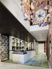 Modern home with Hallway, Ceramic Tile Floor, and Light Hardwood Floor. An installation by Kirsten Hassenfeld hangs above the custom reception desk, which is topped with slate. The floor tiles are 14OraItaliana's iGattipardi line. &Tradition makes the pendant lights and the Vivid Victorian wallpaper is from Flavor Paper. Photo 5 of Drake Devonshire Inn