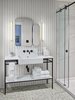 Modern home with Bath Room, Pedestal Sink, Wall Lighting, Enclosed Shower, and Porcelain Tile Floor. The spa-like bathroom features marble tile and a freestanding vanity. Photo 7 of Drake Devonshire Inn