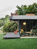 Modern home with Exterior, House, Mid-Century Building Type, and Shingles Roof Material. Speaking to his original design, architect Saul Zaik says, “We were really just building boxes with a bunch of windows but experimenting with how you integrated indoor and outdoor spaces.” The house has seven different openings to the exterior, allowing different courtyard or patio settings for a range of outdoor activities, including seating for a gathering on the street-facing side. The Milfords hired Lilyvilla Gardens for the landscaping around the house, including variegated bluestone steps with thyme joints. Photo of 47+ Midcentury Modern Homes Across America