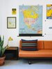 Modern home with Living Room, Carpet Floor, Lamps, Sofa, Table Lighting, and End Tables. The kids' room is outfitted with a cheerful orange Case Study daybed from Modernica and a selection of vintage maps and artwork. Photo of How to Design With Maps