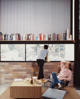 The Schaffer's furniture includes an Eames Aluminum Group lounge chair ("and ottoman!" adds Im.) A coffee table made of glued, corrugated cardboard was the couple's first project together, when they met in college eight years ago.