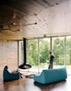Modern home with Living Room, Sofa, Medium Hardwood Floor, and Hanging Fireplace. New Grass Roots
With its corrugated-aluminum exterior, X House in Hennepin, Illinois, was built to resemble rural silos. The inside, however, features rich wood paneling and spare furnishings. From floor-to-ceiling windows, the residents have a view of the surrounding grassland. Photo 3 of New Grass Roots