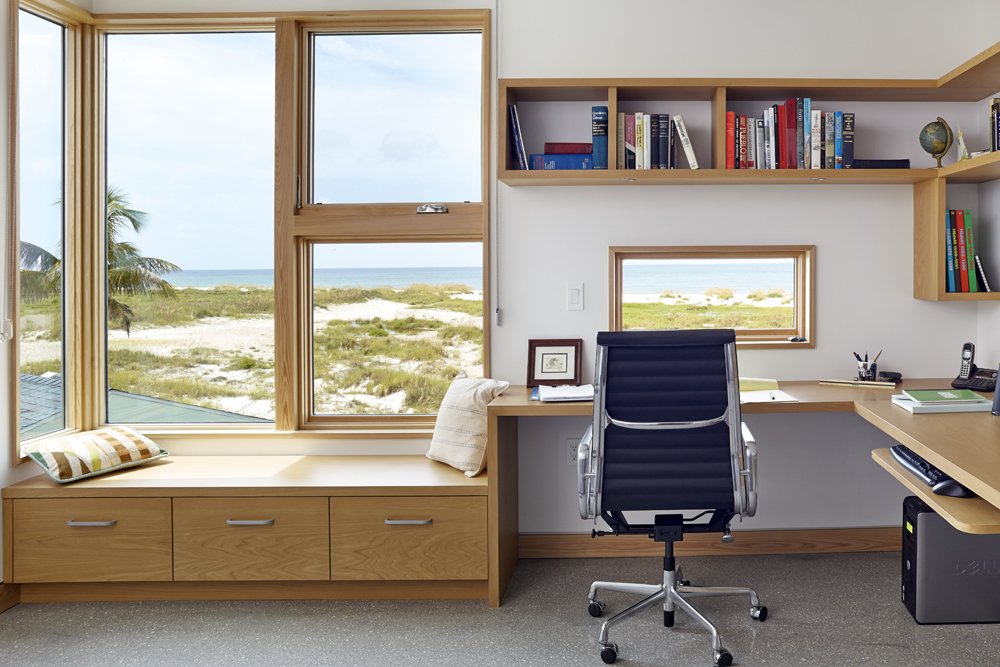 The guest room doubles as a home office. Here, too, are cypress built-ins framing glass panels that look out onto the sea. The architects call them "St. Jerome boxes," which is inspired by the classic image of St. Jerome at his desk, lost in thought, with the landscape framed in a picture window beside him.