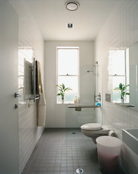 The bathroom’s width and reinforced handrails accommodate Wansbrough’s needs.