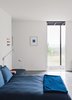 Modern home with Bedroom, Bed, Concrete Floor, and Wall Lighting. The bed is from Design Within Reach. Photo of Our Favorite Bedrooms