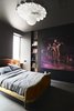 The bedroom is tucked in the back of the residence and doesn’t receive a lot of natural light. The couple emphasized the coziness of the space by painting the walls in Space Black from Benjamin Moore and selecting an oversize artwork, Flotar, 2011, by Christian Curiel. The bed is a Louis XV–style reproduction, approximately from the 1950s, that Gil and DeSimio found on eBay. Photo of Winning Bids: 7 Unbelievable Online Finds modern home