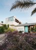 The “lifeguard tower–like” bay window is a bold counterpoint to the original home and offers rewarding ocean views. One of Garcia’s guiding principles is to design “as small a building as practically possible.” This responsible approach was echoed by the owners, who agreed that reusing and rehabilitating the existing house was the best and highest use of the structure. By thoughtfully adding in a way that was minimally impactful to the current structure, the family chose to grow with the home that was already their own. Photo 7 of An Eye-Catching San Diego Addition with a Curved, Two-Story Garage Door modern home