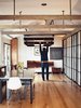 Modern home with Bedroom, Bed, Medium Hardwood Floor, Recessed Lighting, Night Stands, and Chair. When not in use as the headboard, the large redwood slab folds down to become a desk. Photo of Inside 5 Tiny Homes, All Under 600 Feet