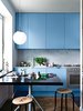 Modern home with Kitchen, Marble Counter, Pendant Lighting, Colorful Cabinet, and Marble Backsplashe. The sink and faucet—notice their reflection in the glass—are by Mora Armatur. Resident Saša Antić purchased the stool from local vintage shop Dusty Deco. A retro Ikea pendant lamp hangs above the kitchen table, which is an architect’s drafting board Antić found at Grandpa, another store in his neighborhood. Photo by: Jonas Ingerstedt Photo of Cozy Scandinavian Abodes