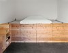 Modern home with Bedroom, Bed, and Shelves. The couple’s bedroom, occupying a space that was once a machine shop, has a cedar sleeping platform designed and built by Elliot Loh. Photo of Unusual Sleeping Spaces