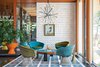 Modern home with Living Room, Ceiling Lighting, Coffee Tables, Chair, Rug Floor, and Pendant Lighting. “There’s no right answer except to play and experiment,” Adler says about furnishing the interior. He reupholstered vintage Warren Platner chairs with velvet from Kravet. Drawings by Eva Hesse inspired the custom ceramic wall tile. Adler also created the coffee table, rug, planters, and gold stool. The pendant lamp is from Rewire in Los Angeles and the artwork is by Jean-Pierre Clément. Photo of Homes Filled with Colorful Furniture