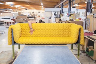 The physically taxing job of assembling the final product is most frequently handled by men in the factory, but Laurence is a nimble, notable exception. After assembling the sofa and fluffing the cover she readies it for shipping and boxes it up.