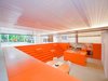 A bright-orange polyurethane coating rescues the dugout from any suggestion of darkness or dinginess. Photo of Parksite Residence, Rotterdam modern home