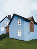 Modern home with Exterior, House Building Type, Wood Siding Material, and Shingles Roof Material. Glimpsed from the outside, it becomes clear how an internal corridor flows through both structures at an uncommon angle. Photo of Blue Mood: 9 Creative Ways to Use Color