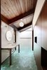 In a sophisticated main bathroom in Seattle, sea-green concrete floor tiles with a geometric pattern provide a lawn of color against wood walls and white tile. The paper lanterns are also a clear homage to the building’s Japanese inspirations. Photo 8 of Zema Redux modern home