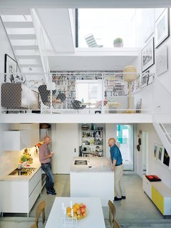 Three thin slabs have been staggered vertically through the space to create three distinct floors and allow light to flood in from the front, back, and roof. The white Saari kitchen makes the most of a compact space.

