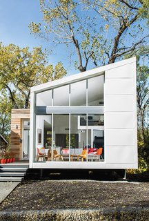 The house that Kem Studio designed for Sarah Magill on a narrow lot in Kansas City has a steel facade with reclaimed cypress cladding near the entrance. The entire structure sits atop a steel foundation set on concrete piers that were driven into solid stone.