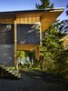 Modern home with Exterior, Cabin Building Type, House, Shed RoofLine, and Wood Siding Material. The cantilevered sleeping loft posed a structural challenge. "The structure is simple, however we explored a number of options for supporting the cantilevered loft," Eerkes says. "But after comparing costs for large trusses versus a big glulam beam—including labor costs for construction of each—the simplicity of a two-foot glulam beam won out. The steel rod cross bracing provided lateral stability in the longitudinal direction." Photo of An Eco-Friendly Compact Cabin in Washington