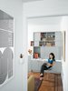 Modern home with Living Room and Chair. The furniture in the living room came a bit more easily. A Knoll chair was a gift from an old employer, as was the poster, by Paula Scher, in the hall leading to the bedroom. Photo of How To: Decorating with Posters