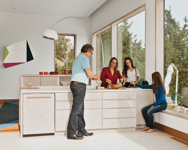 The kitchen is stocked with storage niches for cups and everyday plates. Unloading the dishwasher is a family affair for the architect, her husband, Robert, and two teenage daughters.