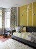 Fisher characterizes the house as having an “understated niceness” to it. “The clients wanted everything nice, but not precious,” Fisher says. “A comfortable and functional home that has hints of fun and colorful interjections—just like them.” Here, a painted wall with decals purchased on Etsy, Restoration Hardware’s Devyn Daybed, a Flokati rug from gilt.com, and custom drapery by Workroom Couture Home mix with a toy piano that’s been in the family for years. Photo 3 of Lakeview modern home