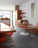Lucy chairs from Bend and an Eero Saarinen Tulip base outfitted with a custom top offer places to eat and sit in the kitchen. Porcelain tile lines the floor. Photo 5 of Lakeview modern home