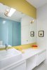Benjamin Moore’s Mustard Field paint adds a vibrant touch to another bathroom in the house. Photo 8 of Lakeview modern home