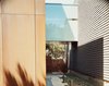 Modern home with Outdoor, Walkways, Hardscapes, Side Yard, and Wood Fences, Wall. The frosted-glass bridge unites the original 1950s structure (right) to the new addition, which is sheathed in Cor-ten steel panels. Photo of Designing for Privacy: 14 Discreet Uses For Frosted Glass