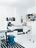 Modern home with Kitchen and White Cabinet. Fine Finnish
In the kitchen of this tightly-packed apartment in Helsinki, Finland, Susanna and Jussi tore down the ceiling and wall cabinets with the help of Jussi’s father, a skilled craftsman. “Behind the cabinets we found lovely little nooks that work perfectly as shelves for things like salt and pepper mills. When you strip everything to its original state, you are able to see what the house is truly about.”
Photo by: Petra Bindel Photo of Architects Get Crafty With Budgets to Build Cost-Effective Modern Homes