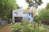 Modern home with Outdoor, Gardens, and Garden. Adventurous but subtle. Something different that doesn’t scream for attention. These were the prompts John and Erika Jessen gave to architect Elijah Huge for the addition to their 1920s home in New Haven, Connecticut. Photo by Andrew Rowat. Photo of 16 Funky Facades
