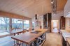A wood-burning stove that had occupied the clients’ previous home now dominates the bungalow’s main room. “It’s the heart of the house and serves for cooking as well as for heating,” Klauser says. The space is filled with furniture purchased in antique stores or crafted by the residents themselves, though the cooking table was made by a local metalworker. Photo of Kitchens with Killer Views modern home