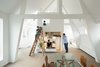 Japanese firm Mamm Design renovated this maisonette apartment in Amsterdam. Home to a family of four, the dwelling combines a series of bright, open spaces. The kitchen and bathroom, for example, are placed in this freestanding tower topped by a ladder-accessible mezzanine. Photo of These Contemporary Homes Defy Convention modern home