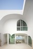 Dramatic arches characterize this enigmatic California beach house that's elevated six feet above the sand to guard from major storms. Called the Vault House, it was designed by architecture firm Johnston Marklee. As principal Mark Lee explains: “The envelope was so strict that the design process was more subtractive than additive; we carved away a solid mass to create the rooms. We were reluctant to broadcast the content right away, preferring to mask the complexity and reveal it a little at a time.” Photo of These Contemporary Homes Defy Convention modern home