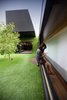 Architect Andrew Maynard designed this home in Melbourne, Australia. Called the Hill House, its form is defined by a cantilevered box that juts over an Astroturf-clad hill. A three-foot-wide corridor opens up to an expansive, open courtyard that draws sunlight into the property. Photo of These Contemporary Homes Defy Convention modern home