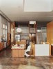 The kitchen and dining area is furnished with a salvaged timber table designed by Matt Eastvold, white Panton chairs, and a Glo Ball pendant lamp. Photo of Take Two: 7 Adaptive Reuse Projects We Love modern home