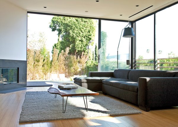 The sofa is from Cantoni, the rug is from Restoration Hardware, and the Tolomeo floor lamp is by Michele 

De Lucchi for Artemide. The large windows in the background and throughout the house are from Western Window Systems.