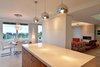 The 1Light pendants above the kitchen island are from Eurofase. Photo of Kitchens with Killer Views modern home