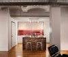Modern home with Kitchen and White Cabinet. To update the kitchen for this apartment in the Leather District, Chris Greenawalt of Bunker Workshop and contractor Michel Beaudry created a clean-lined space. The space is designed to accommodate the client's busy schedule, which affords him little time for cooking. Photo of Clever Red Pegboard Backsplash in a Remodeled Kitchen