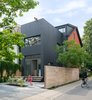 Modern home with Outdoor, Back Yard, Stone Patio, Porch, Deck, Trees, Wood Fences, Wall, Horizontal Fences, Wall, Hardscapes, and Walkways. “Sustainability is very important to us,” lead architect Heather Dubbeldam says. “It is easy to design with passive systems, to use passive sustainable principles to influence the design and layout of the house.” Her team reduced the need for air conditioning and artificial lighting through carefully positioned doors and windows that draw in natural light and breeze. New insulation, low-flow plumbing fixtures, and low-energy lighting also minimize the homeowners’ dependence on utilities. Photo of Contrast House
