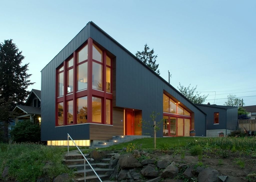 At the lower left, polycarbonate panels glow under the cantilevered, vertically-seamed sheet-metal facade.

Photo credit: Dale Christopher Lang PhD AIAP