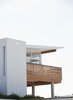 Modern home with Exterior, Mid-Century Building Type, and House. All-vinyl siding on the original shell was replaced with natural plywood T1-11 cladding. The second story features engineered brushbox wood plank, as well as Batu decking for the railing and lanai (a sheltered, open-sided patio). Photo 2 of Hillside House No. 3