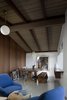Modern home with Dining Room, Table, Bench, Chair, and Pendant Lighting. The dining room table is made from recycled teak railroad ties from Indonesia. The blue armchairs were a Craigslist purchase. IKEA pendant lights contrast nicely with the dark wood. Photo 4 of Hillside House No. 3